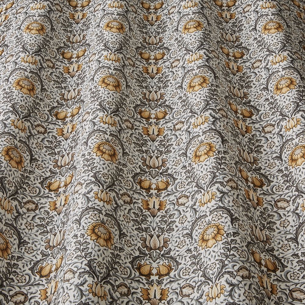 Close-up of Garnett Ochre fabric showcasing its detailed floral design in ochre and grey, perfect for arts and crafts or home décor use.