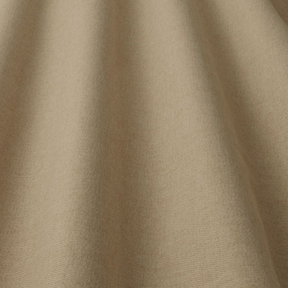 Glenmore Plain Fabric Bisque draped to showcase its smooth texture and durable quality for upholstery applications.