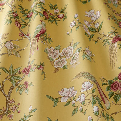 Close-up of Sakura Kyoto Jasmine cotton fabric showcasing intricate floral patterns and birds on a yellow background for home décor projects.