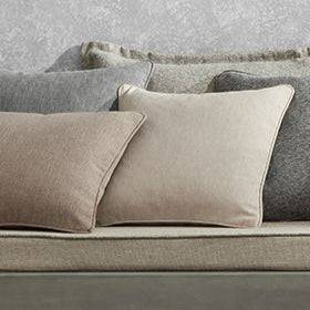 Looma Sustainable Woven Ivory cushions styled on a neutral sofa, showcasing eco fabric's versatility for upholstery and home décor.