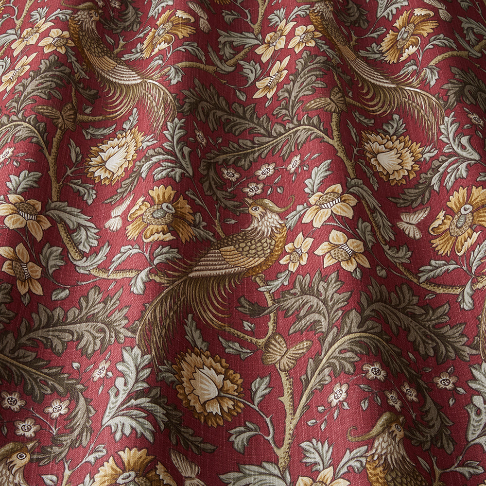 Close-up of Opus Floral Carmine cotton fabric showcasing detailed floral and bird motifs in warm hues, perfect for drapes and creative arts projects.