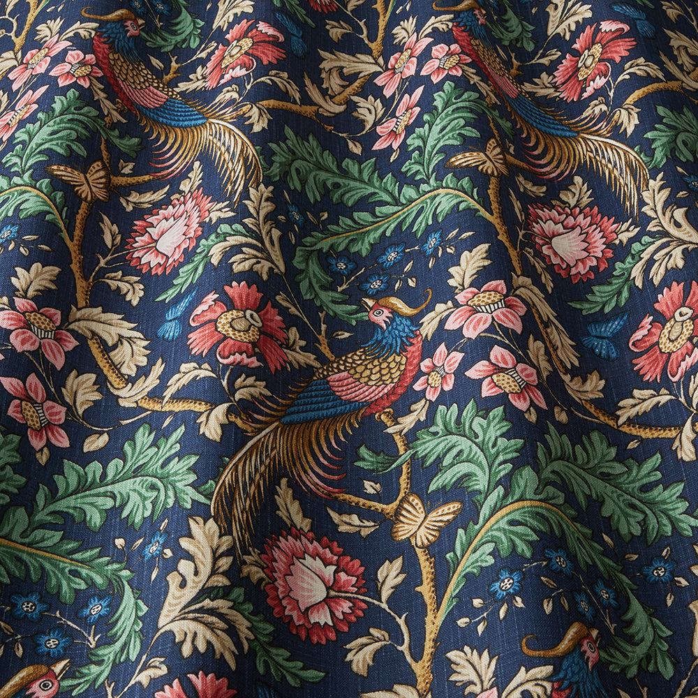 Close-up of Opus Floral Indigo cotton fabric showcasing detailed floral and bird motifs on a rich indigo background, perfect for creative arts and crafts projects.