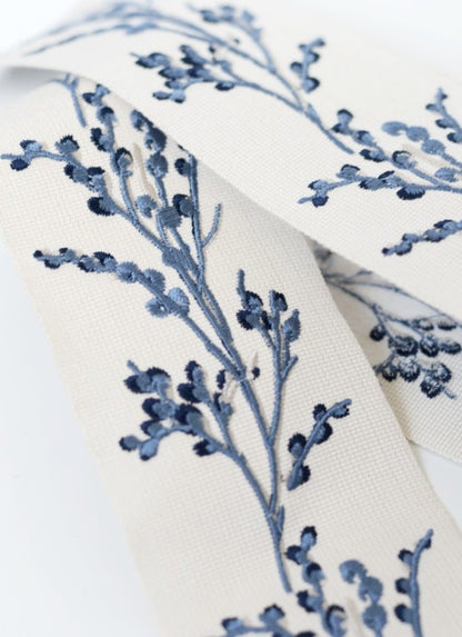 Laura Ashley Border Pussy Willow Seaspray trim featuring delicate blue floral embroidery on a white fabric, ideal for elegant curtains or home decor.