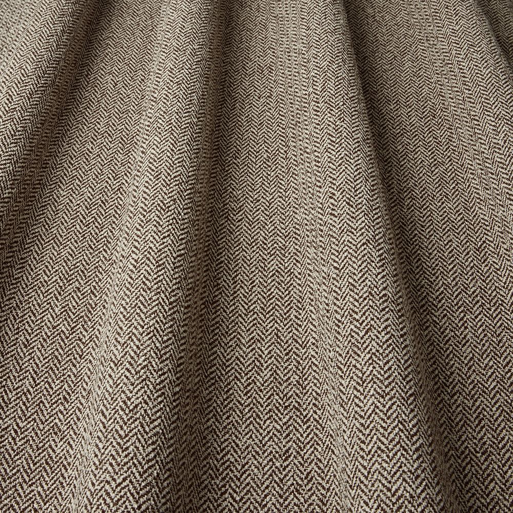 Close-up of herringbone patterned fabric in brown and beige.