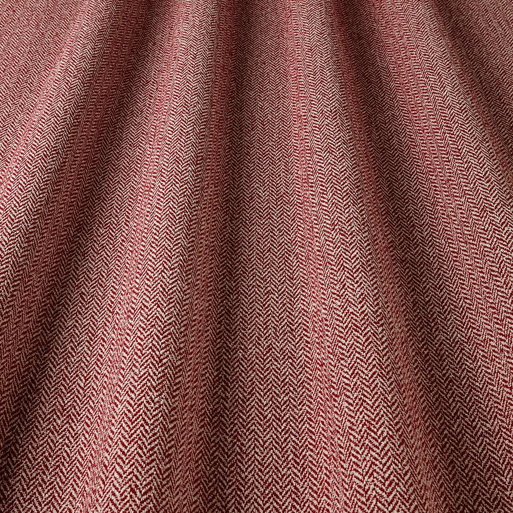 Close-up of a textured fabric with a herringbone pattern in shades of brown.