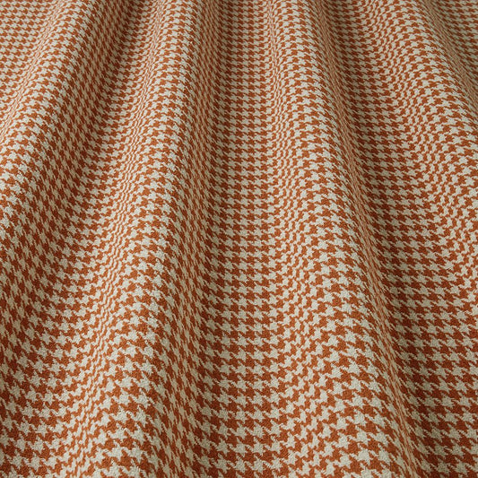 Close-up of houndstooth pattern fabric with Cayenne and white colours.