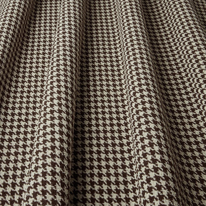 Close-up of houndstooth pattern fabric with brown and beige colors.