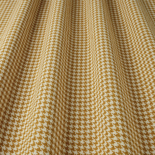 Close-up of houndstooth pattern fabric with gold and white colours.
