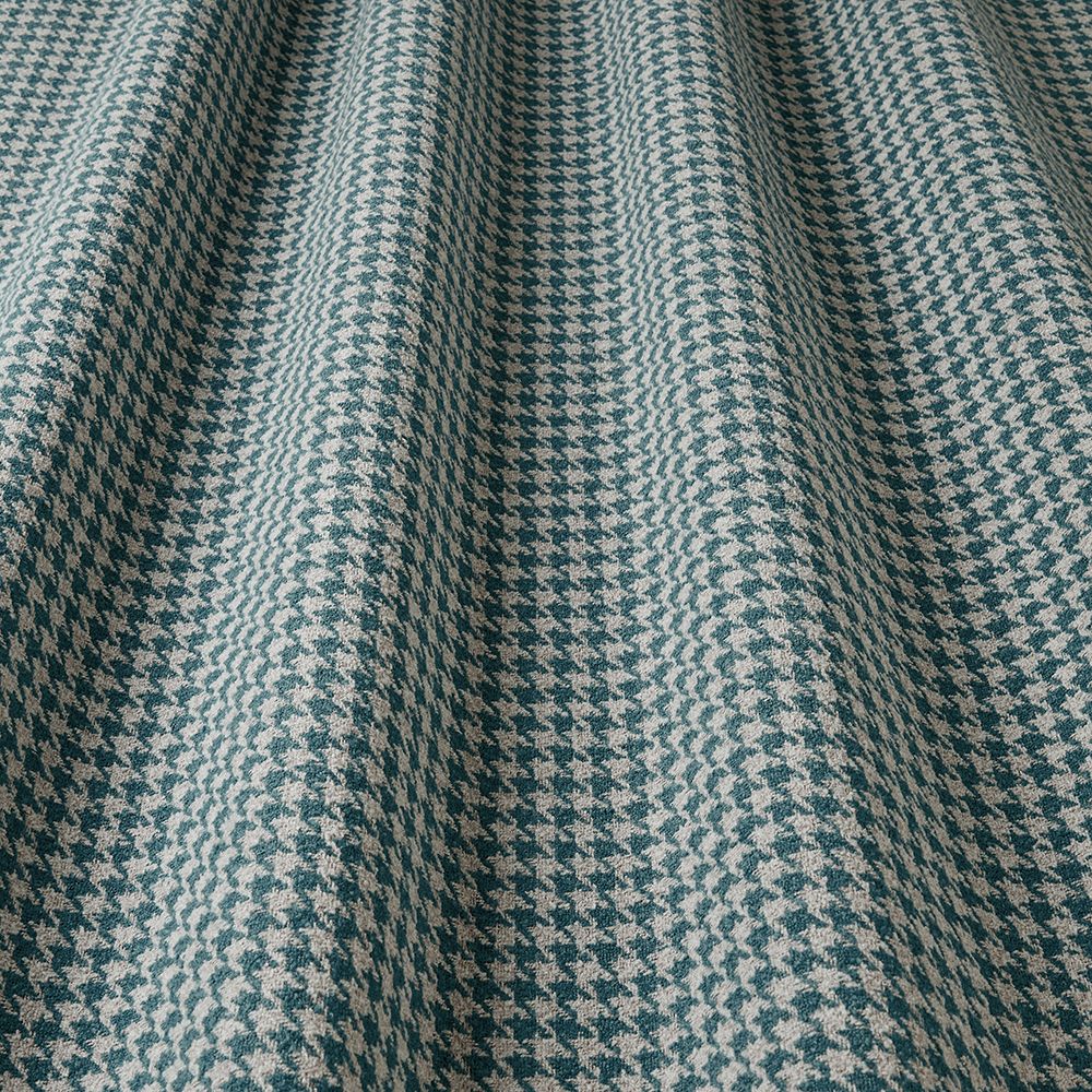 Close-up of a houndstooth patterned fabric in blue and beige.
