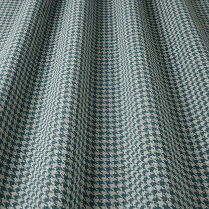 Close-up of a houndstooth patterned fabric in blue and beige.