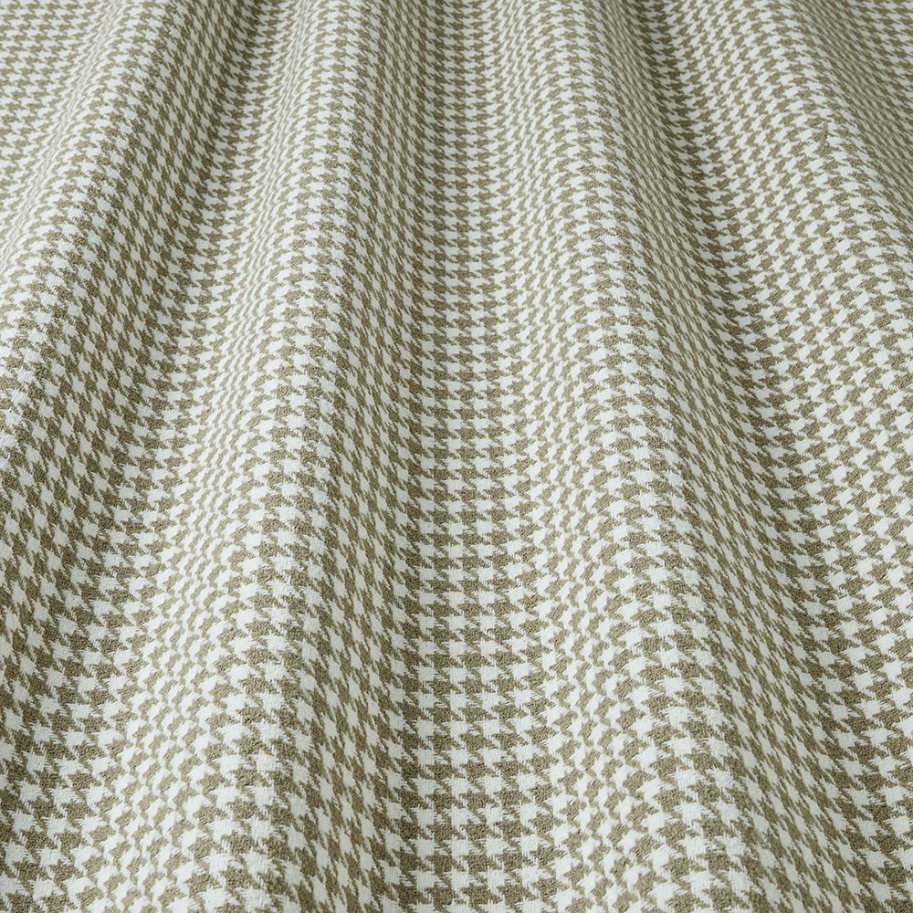 Close-up of houndstooth pattern fabric in olive and white