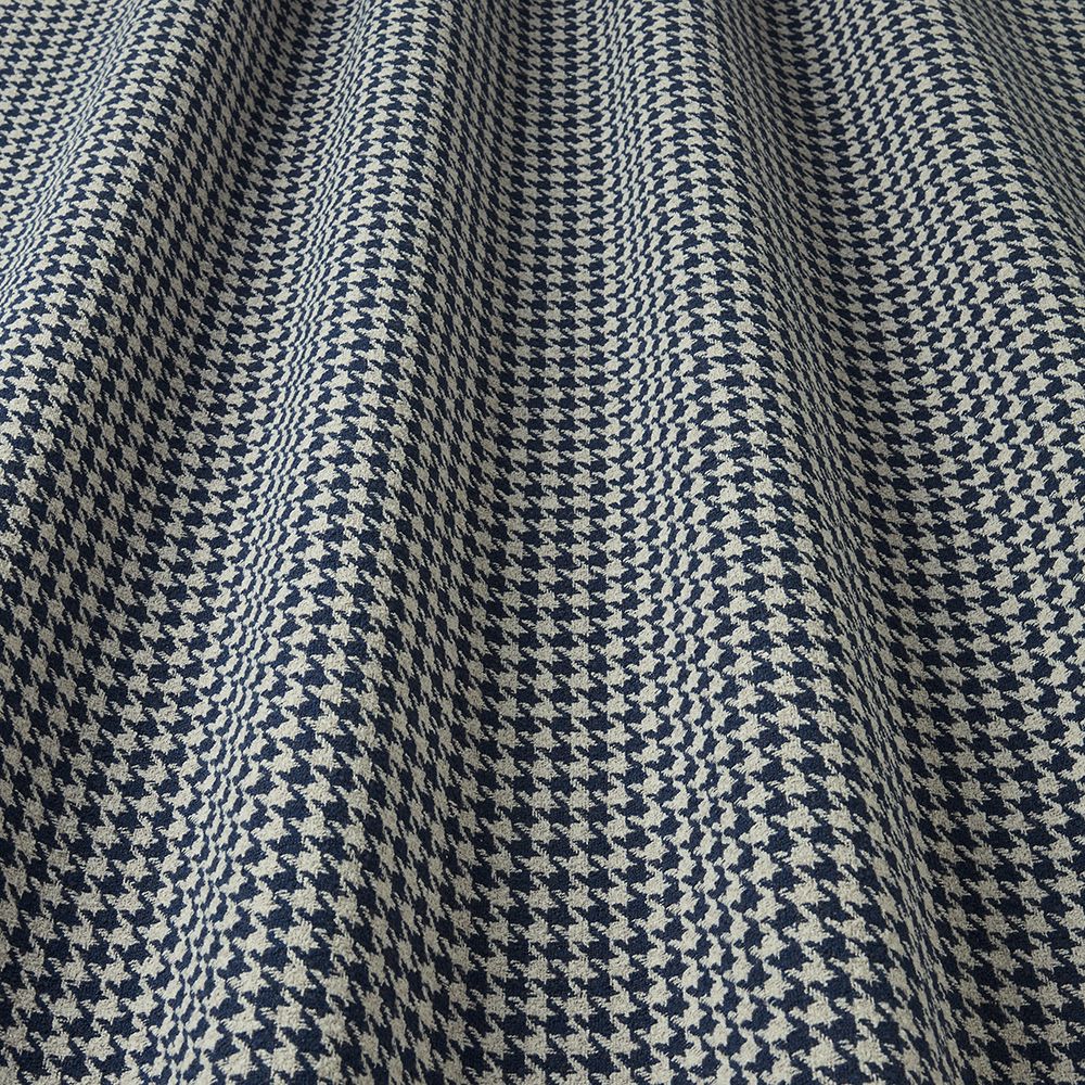 Close-up of a houndstooth patterned fabric in blue and white.