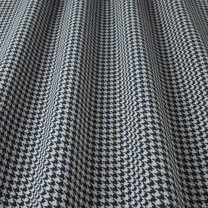 Close-up of a houndstooth patterned fabric in blue and white.