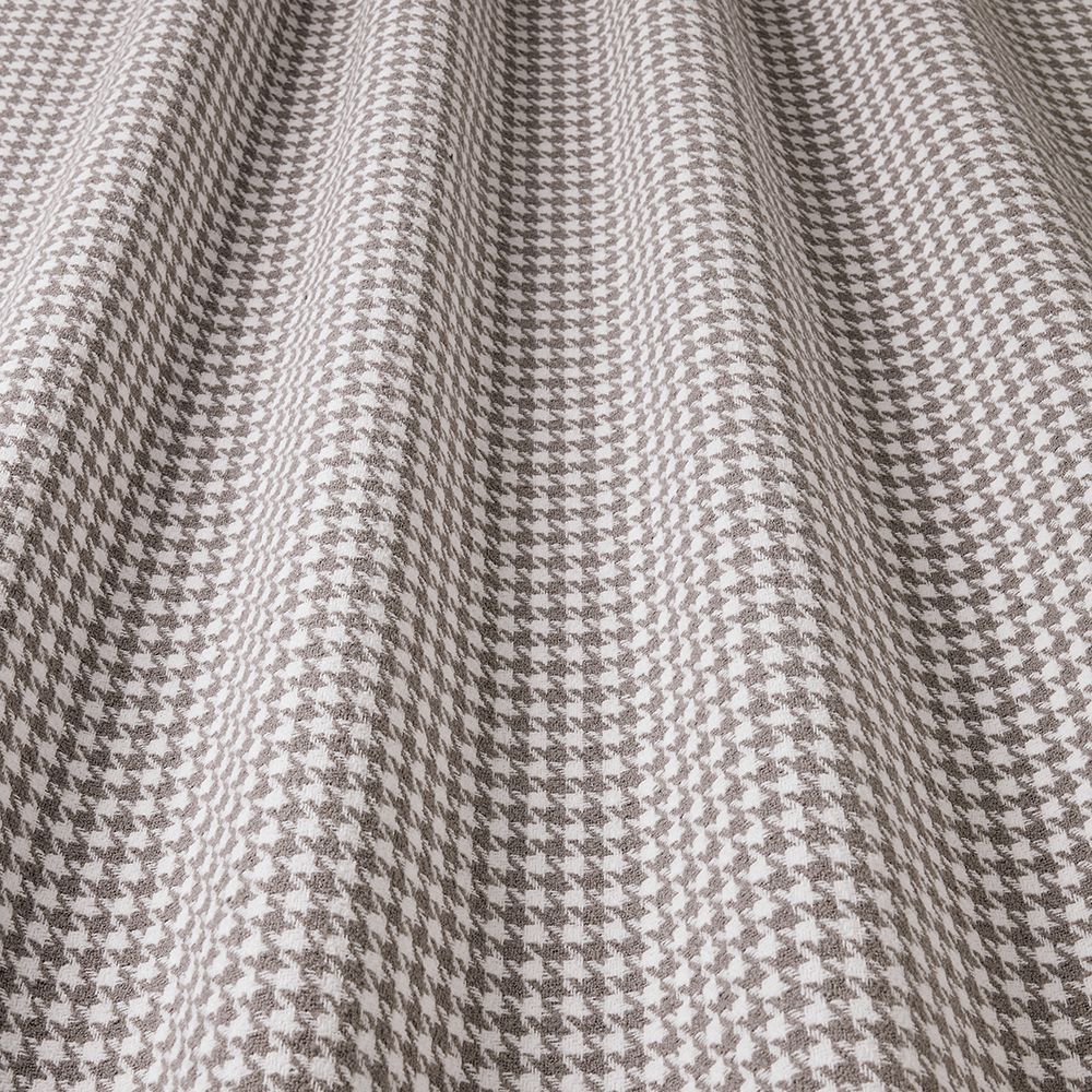 Close-up of houndstooth pattern fabric in gray and white.
