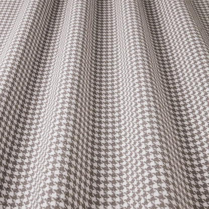 Close-up of houndstooth pattern fabric in gray and white.