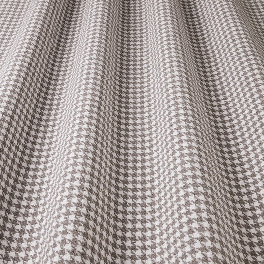 Close-up of houndstooth pattern fabric in gray and white.