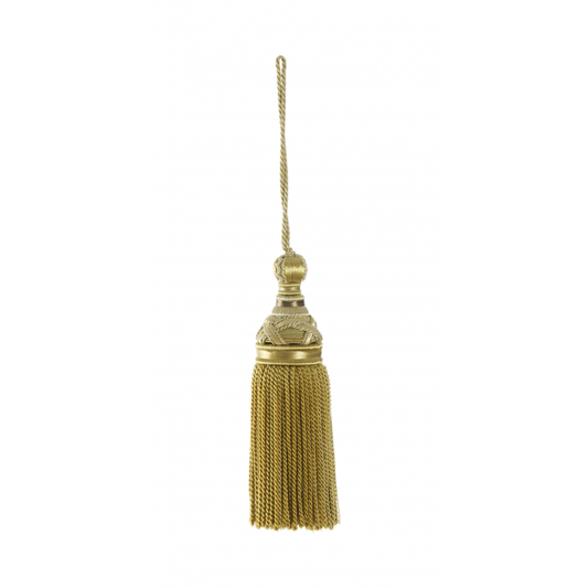 Gold key tassel with decorative top on a white background