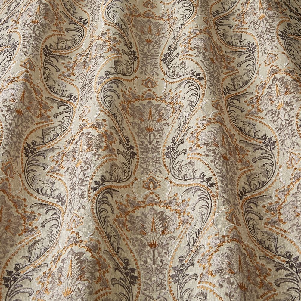 Close-up of Sonrel Floral Saffron fabric showcasing detailed art nouveau patterns with flowing floral designs in saffron and grey hues.