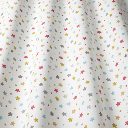 Close-up of Starburst Multi cotton fabric with colourful star pattern, great for children's curtains, blinds, and upholstery in creative spaces.