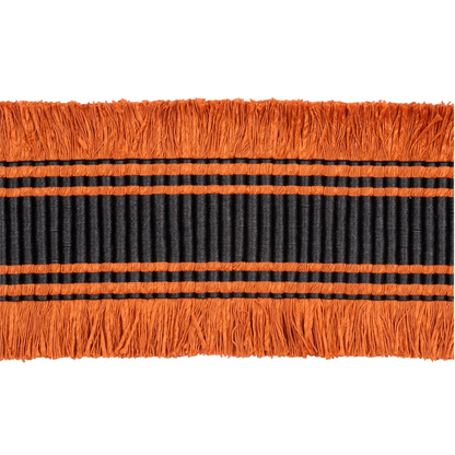 Close-up of orange and black wide braid trim with fringes on a white background
