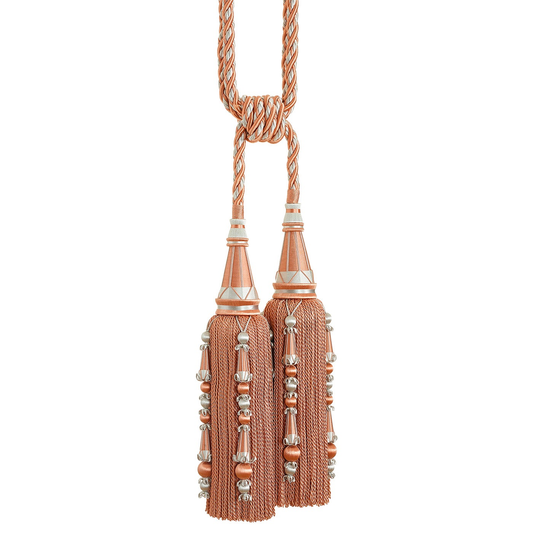 Decorative tassel tieback with rose gold and silver accents on a white background