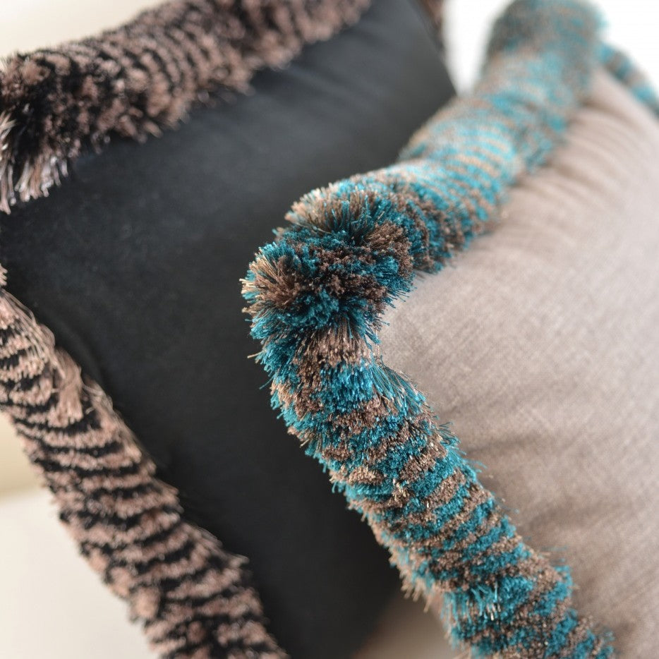 Cushion detail with Valenza Two Tone Brush Fringe in Veridigris Royale and Black Truffle