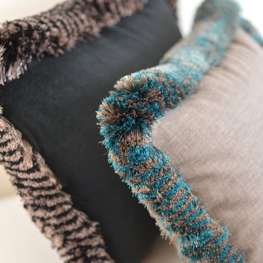 Cushion detail with Valenza Two Tone Brush Fringe in Veridigris Royale and Black Truffle