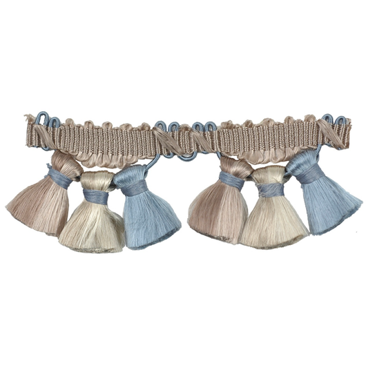 Decorative trim with tassels in beige and blue on a white background