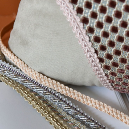 Close-up of various textured fabric samples on a white background