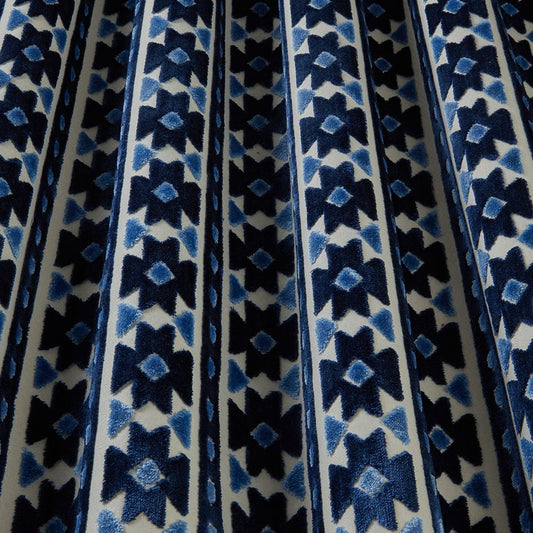 Zanzibar Velvet Sapphire fabric with bold geometric patterns in rich blue tones, ideal for drapes and upholstery projects.