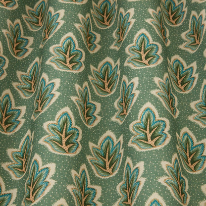 Close-up of Ziro Leaf Fern fabric showcasing detailed Indian-style leaf patterns on a textured green background for home furnishings.