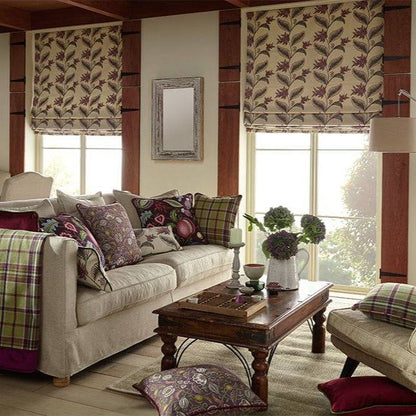 Living room décor with Climbing Fruitlet Thistle fabric used for Roman blinds, cushions, and throws, showcasing its arts and crafts floral design.