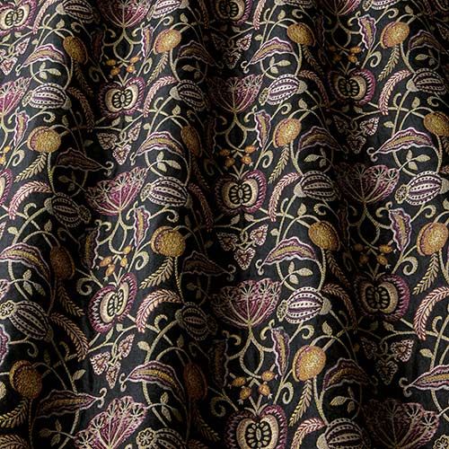 Orchard Eden fabric with a woven leaf and fruit design on a black background, ideal for arts and crafts projects.